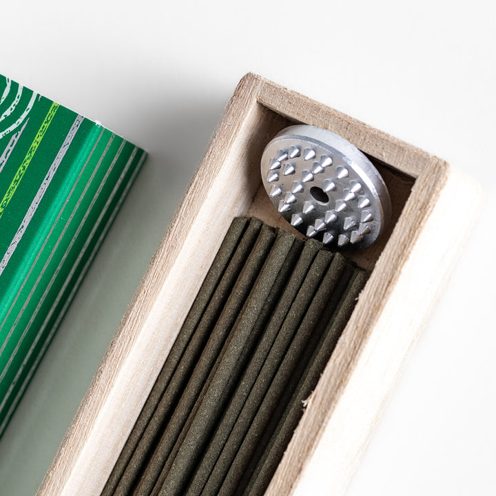 Citrusy Bergamot Incense in a light wooden box with earthy green sticks, elegantly packaged in a vibrant green design featuring white circular patterns, evoking a fresh and uplifting citrus aroma.