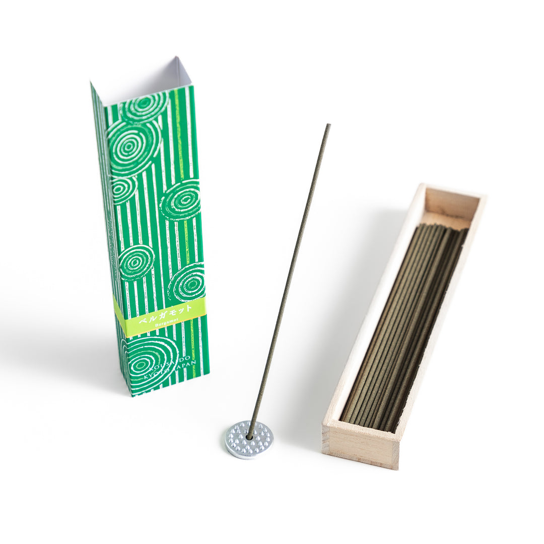 Citrusy Bergamot Incense in a light wooden box with earthy green sticks, elegantly packaged in a vibrant green design featuring white circular patterns, evoking a fresh and uplifting citrus aroma.