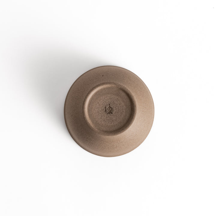 Bottom view of a gray ceramic teacup, showcasing its base and craftsmanship details.