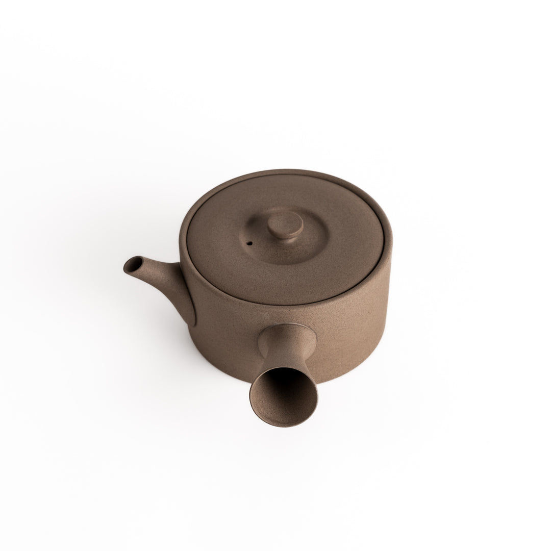 Slightly angled view of the gray teapot, highlighting its elegant shape and horizontal spout and handle design.