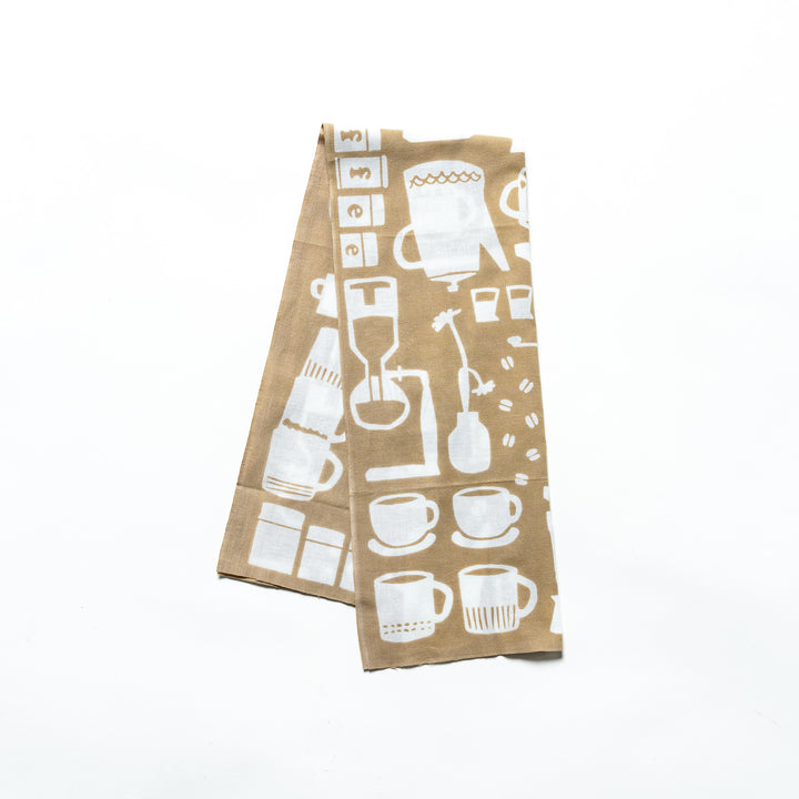 A beige tenugui hand towel with white coffee-themed patterns, including coffee cups, pots, and barista tools.