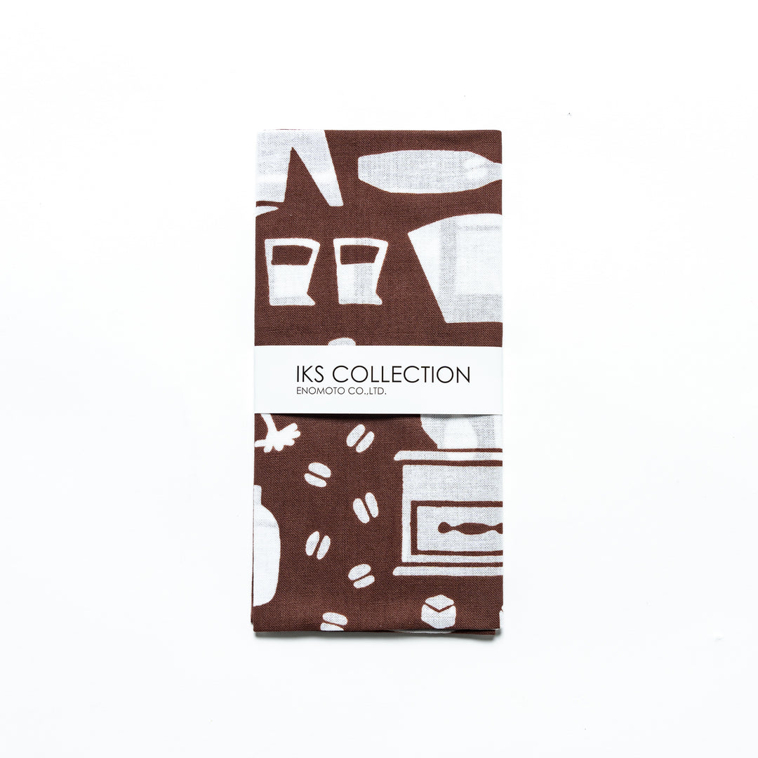 A neatly folded brown tenugui with a branded paper sleeve, showcasing barista-themed patterns.