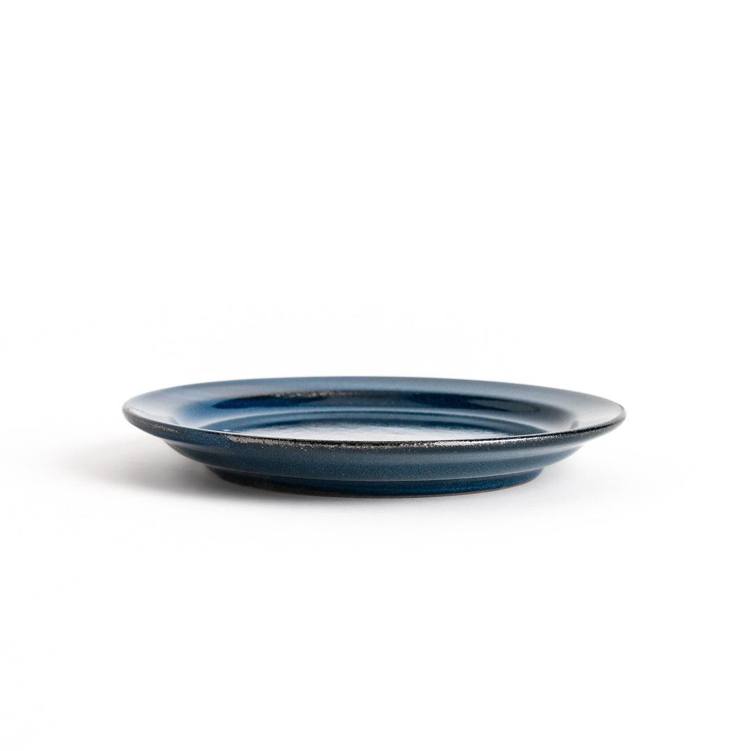 Blue ceramic dessert plate with a glossy finish and minimalist design, perfect for serving small treats or appetizers elegantly.