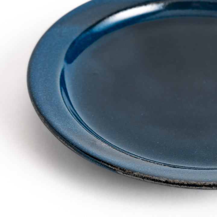 Blue ceramic dessert plate with a glossy finish and minimalist design, perfect for serving small treats or appetizers elegantly.