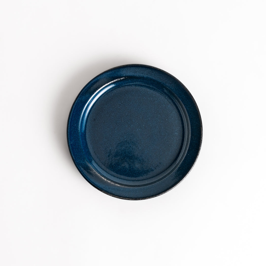 Blue ceramic dessert plate with a glossy finish and minimalist design, perfect for serving small treats or appetizers elegantly.