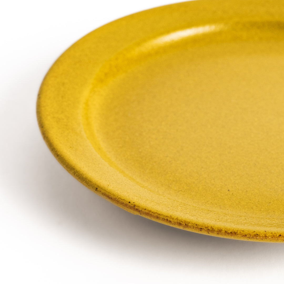 Yellow ceramic dessert plate with a glossy finish and minimalist design, perfect for serving small treats or appetizers elegantly.