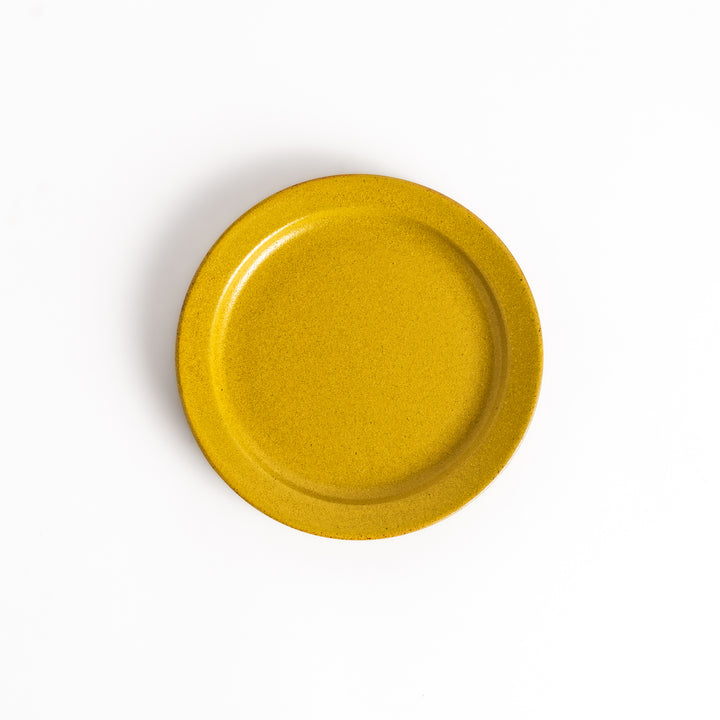 Yellow ceramic dessert plate with a glossy finish and minimalist design, perfect for serving small treats or appetizers elegantly.