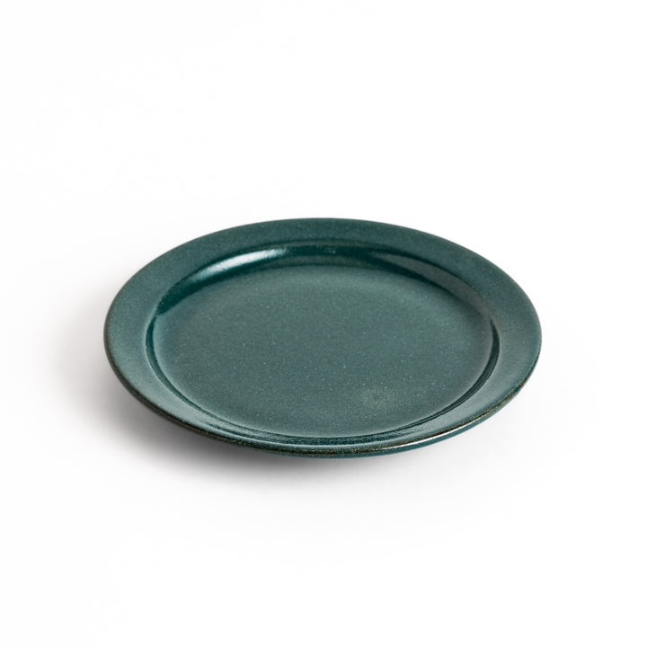 Green ceramic dessert plate with a glossy finish and minimalist design, perfect for serving small treats or appetizers elegantly.