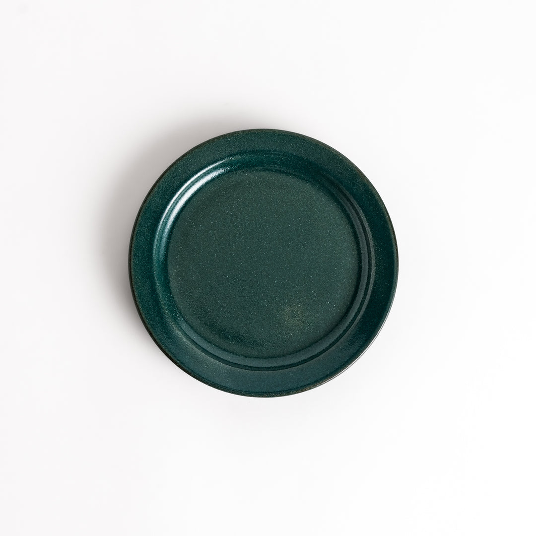 Green ceramic dessert plate with a glossy finish and minimalist design, perfect for serving small treats or appetizers elegantly.