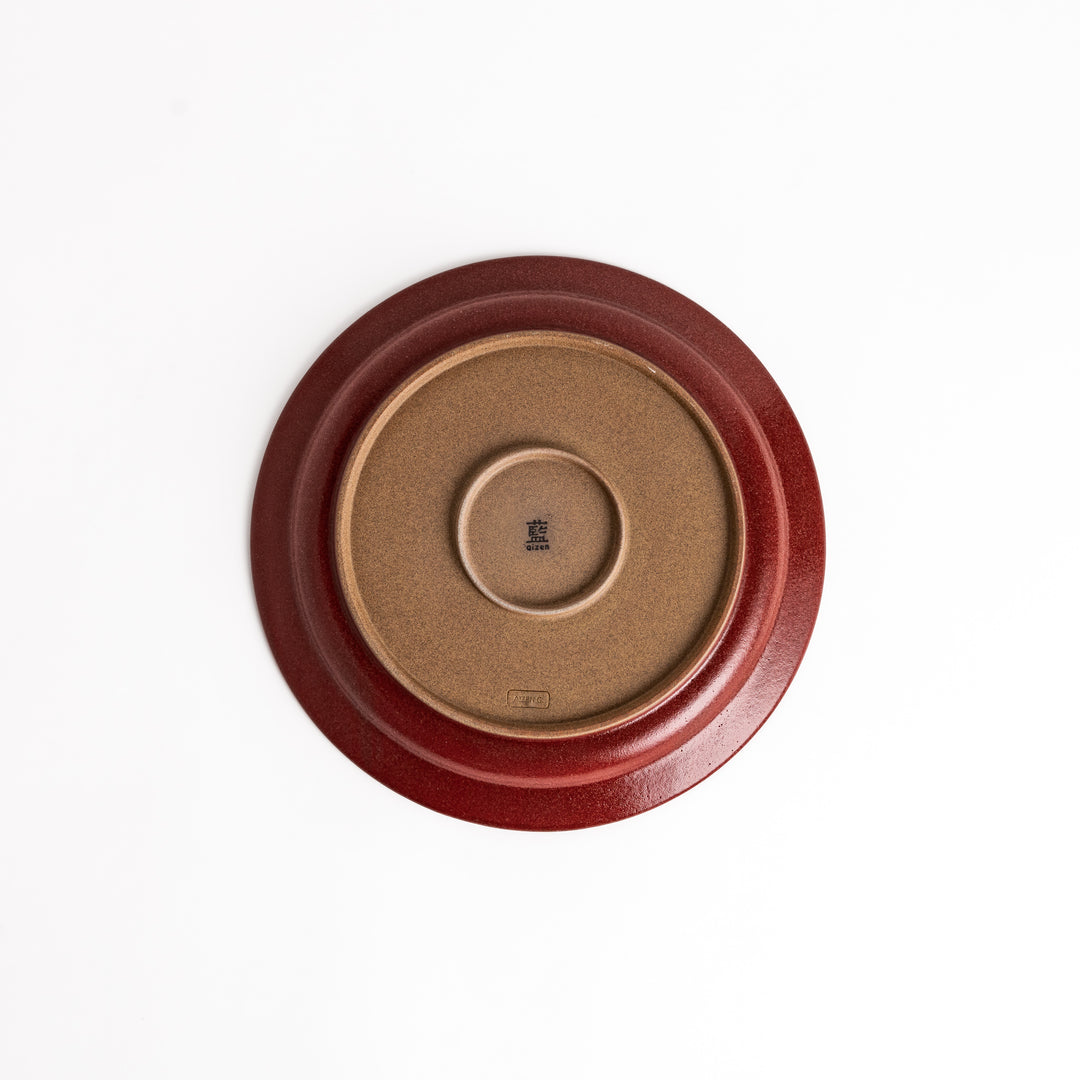 Red ceramic dinner plate with a glossy finish, providing a bold and vibrant accent to any dining arrangement.