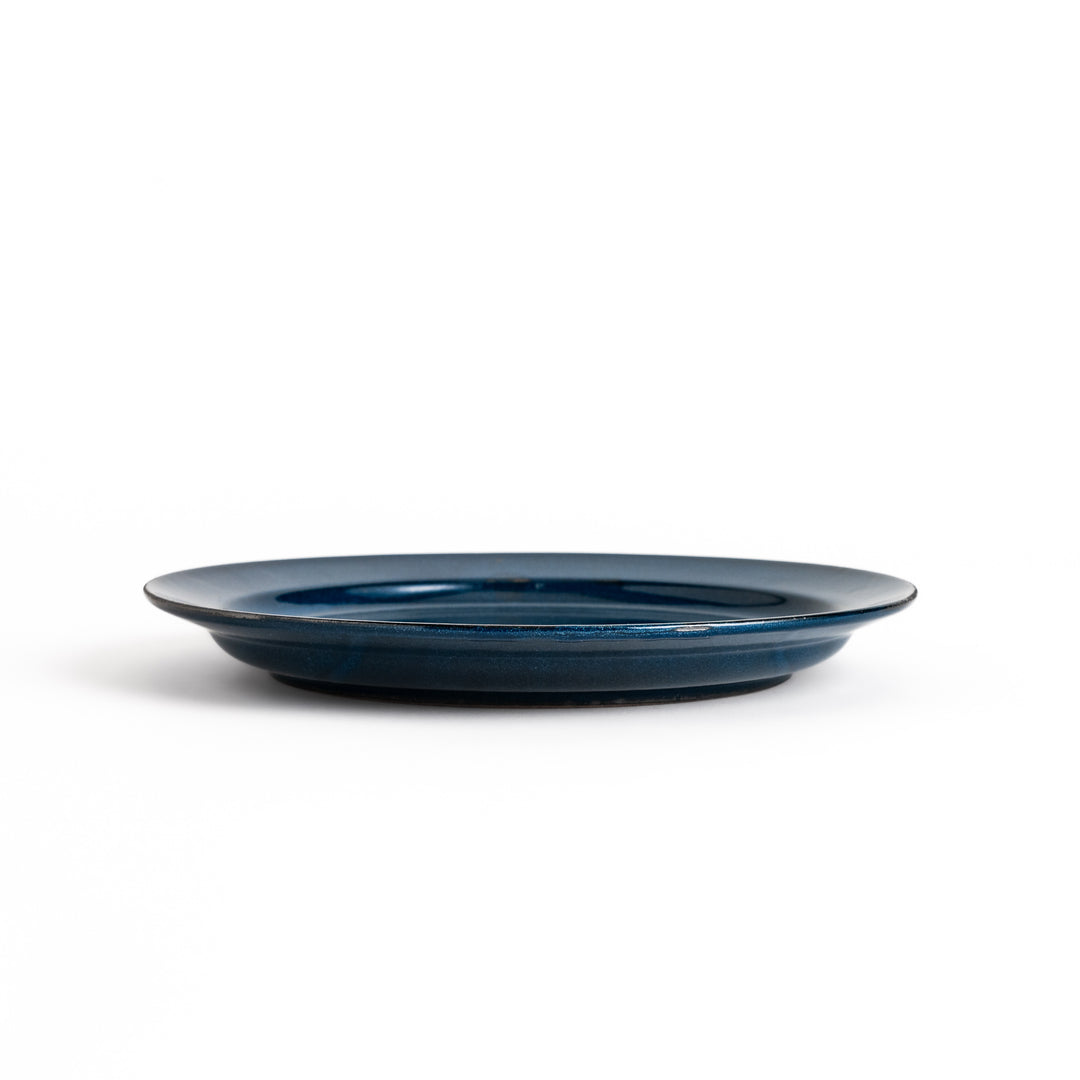 Blue ceramic dinner plate with a glossy finish, featuring a deep, calming tone that complements a modern table setting.