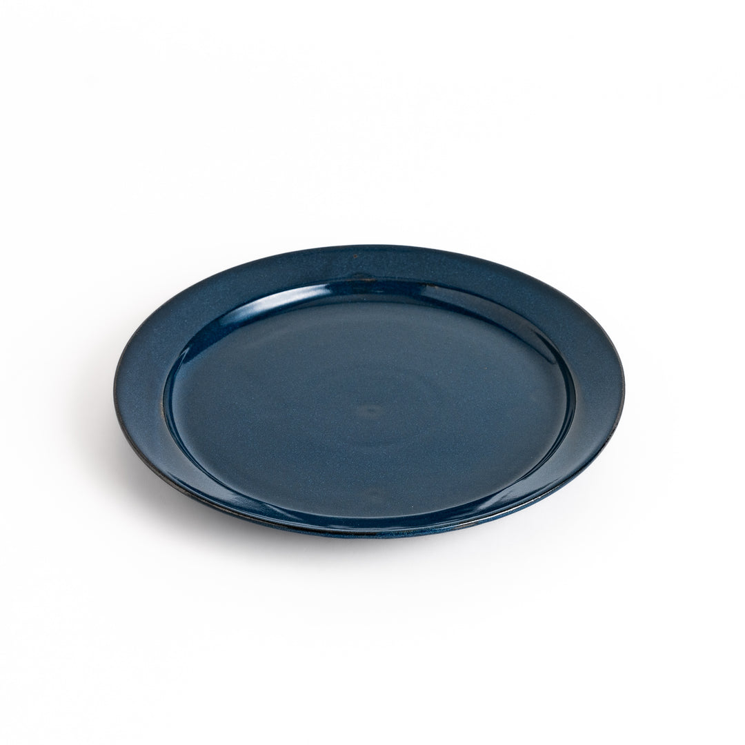 Blue ceramic dinner plate with a glossy finish, featuring a deep, calming tone that complements a modern table setting.