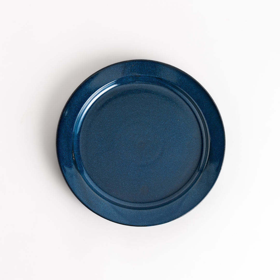 Blue ceramic dinner plate with a glossy finish, featuring a deep, calming tone that complements a modern table setting.