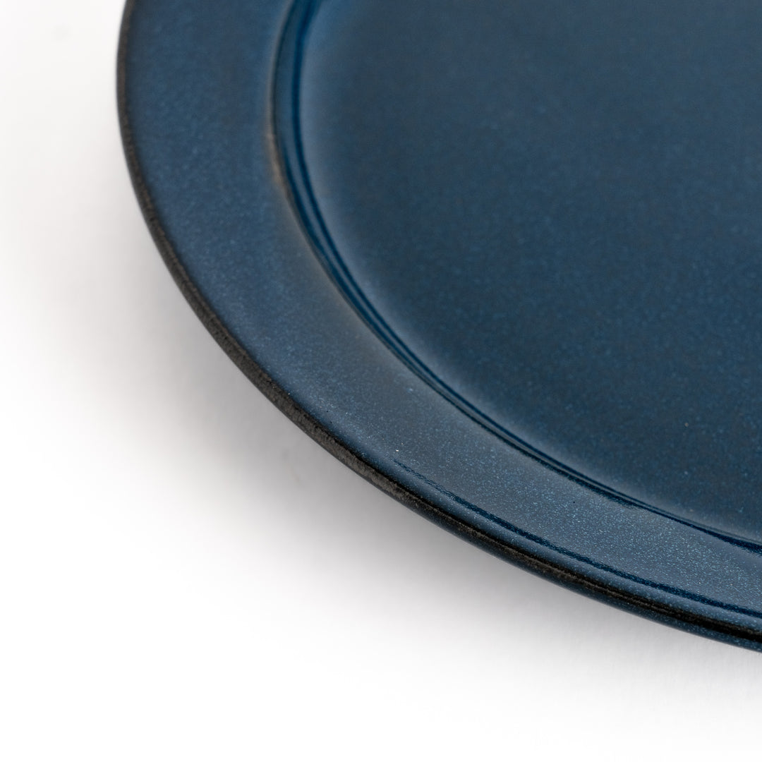 Blue ceramic dinner plate with a glossy finish, featuring a deep, calming tone that complements a modern table setting.