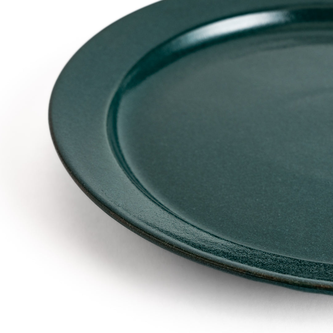 Green ceramic dinner plate with a glossy finish, showcasing a refreshing color that enhances natural or earthy table decor.