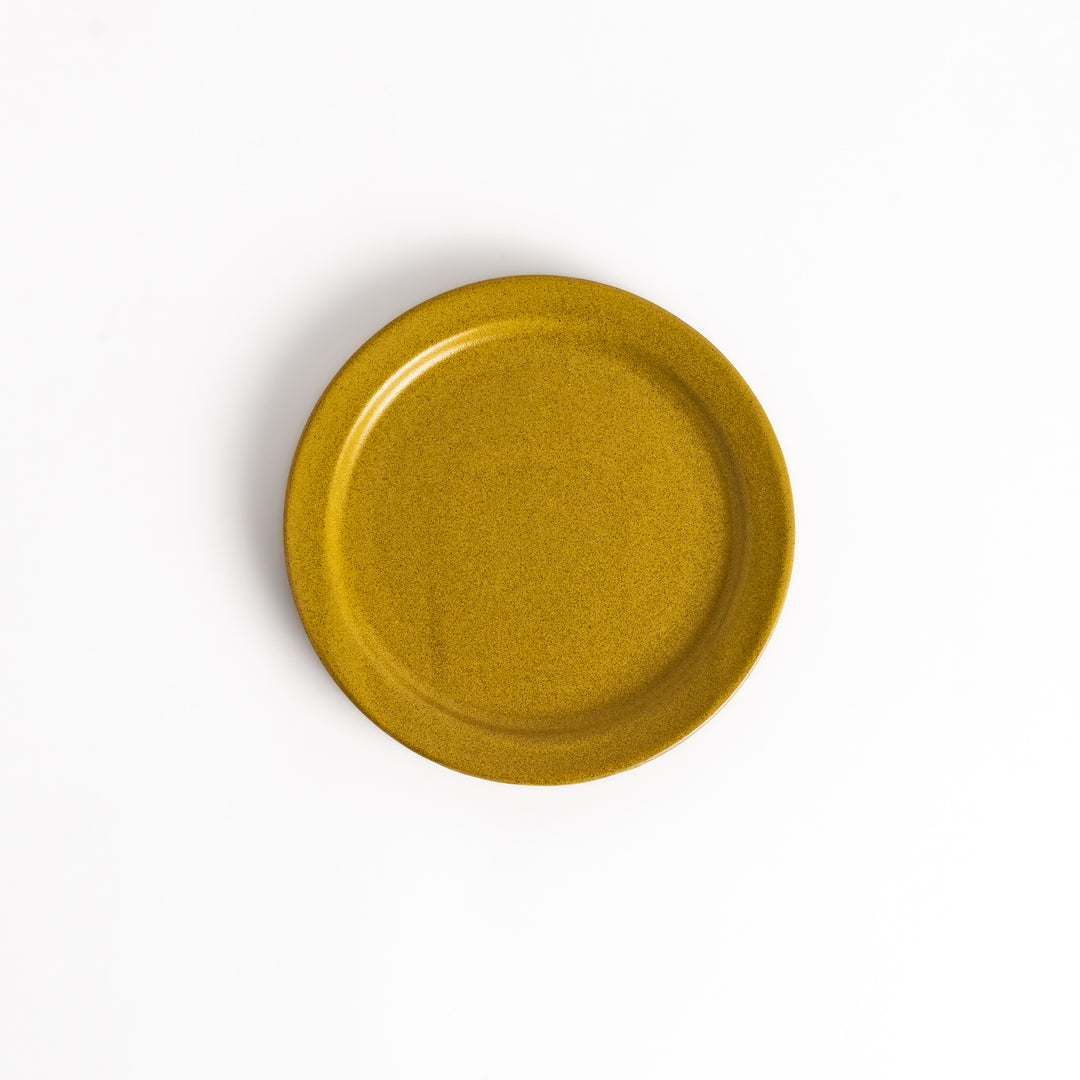 Elegant yellow salad plate with a smooth matte glaze, perfect for presenting salads or side dishes stylishly.