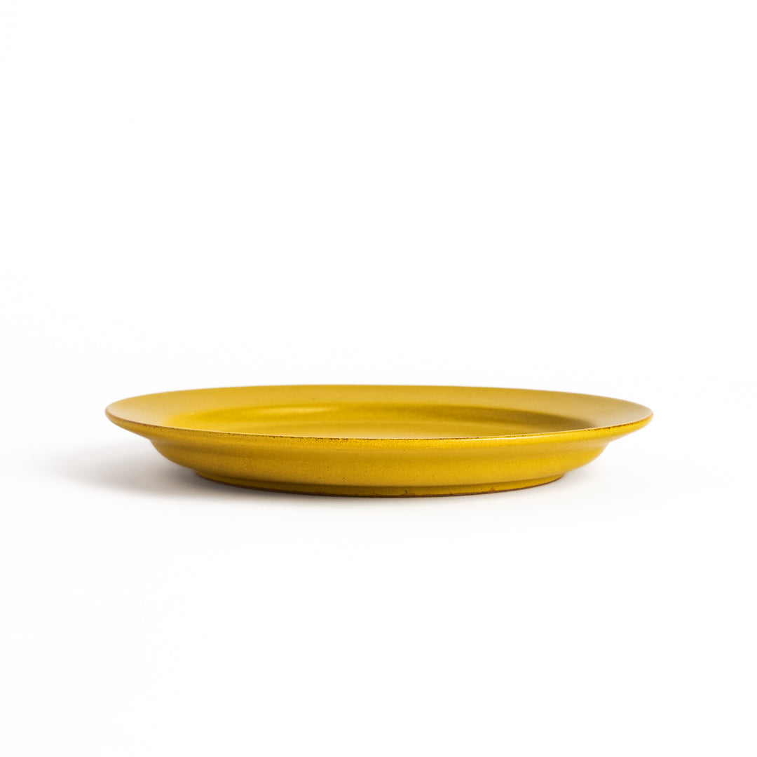 Yellow ceramic dinner plate with a glossy finish, bringing a cheerful and bright touch to any dining experience.