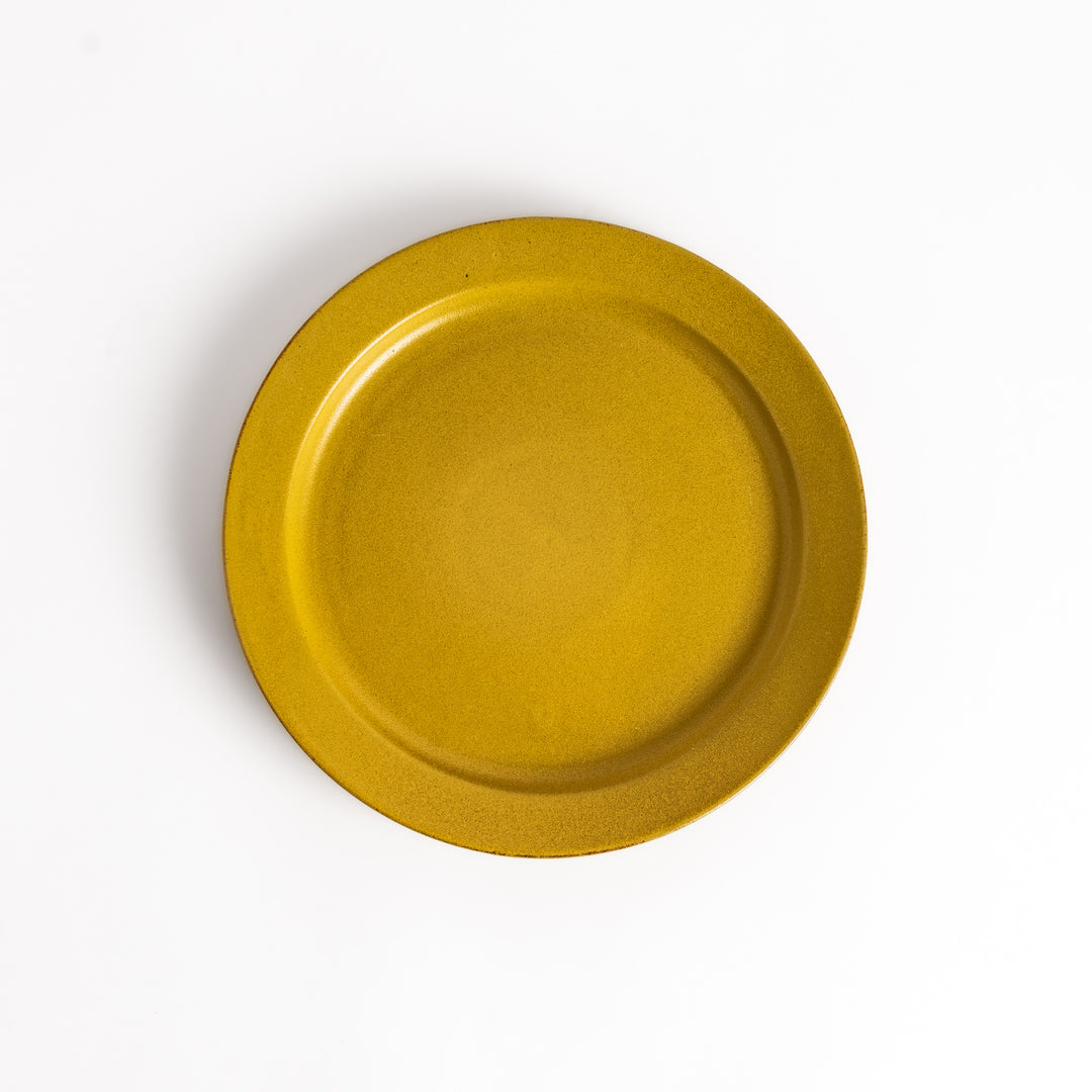 Yellow ceramic dinner plate with a glossy finish, bringing a cheerful and bright touch to any dining experience.