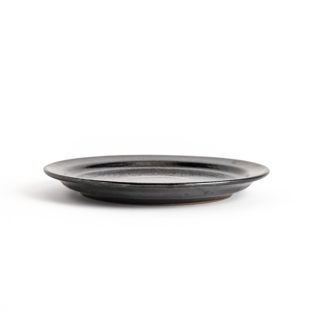 Elegant black salad plate with a smooth matte glaze, perfect for presenting salads or side dishes stylishly.