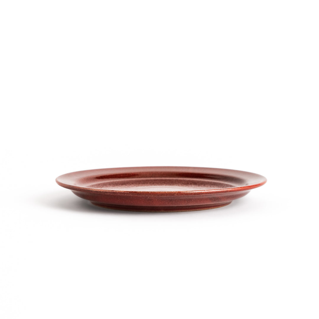 Elegant red salad plate with a smooth matte glaze, perfect for presenting salads or side dishes stylishly.