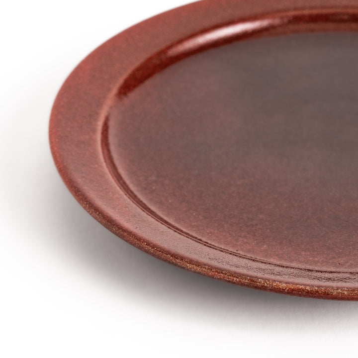 Elegant red salad plate with a smooth matte glaze, perfect for presenting salads or side dishes stylishly.