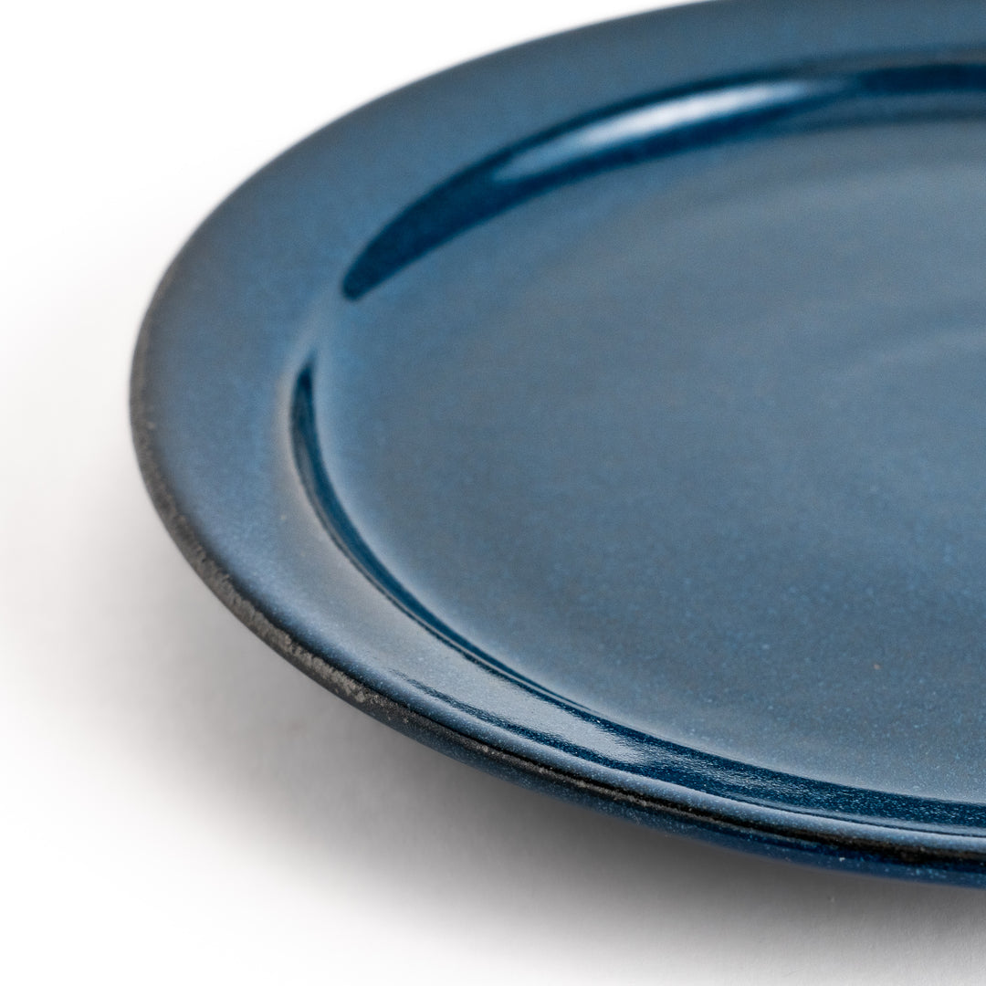 Elegant blue salad plate with a smooth matte glaze, perfect for presenting salads or side dishes stylishly.