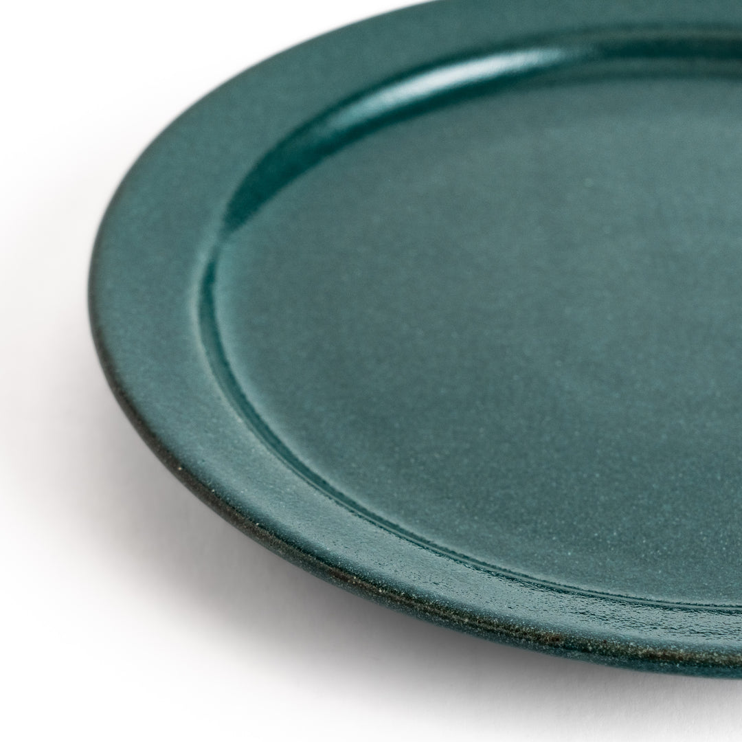 Elegant green salad plate with a smooth matte glaze, perfect for presenting salads or side dishes stylishly.