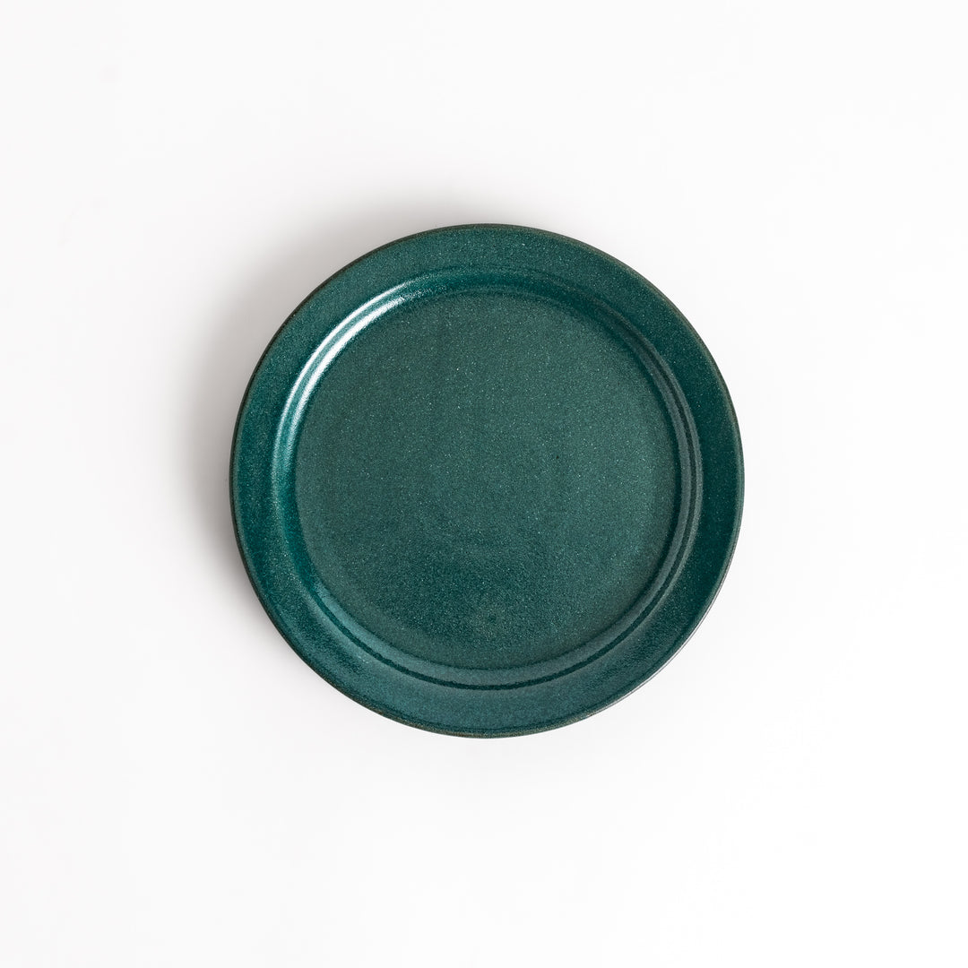 Elegant green salad plate with a smooth matte glaze, perfect for presenting salads or side dishes stylishly.