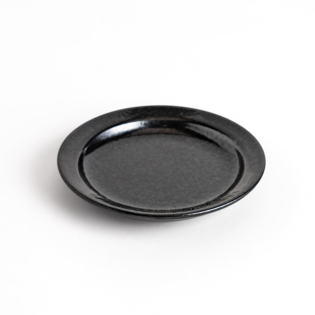 Black ceramic sauce dish with a glossy finish and a minimalist design, ideal for serving dips or condiments elegantly.