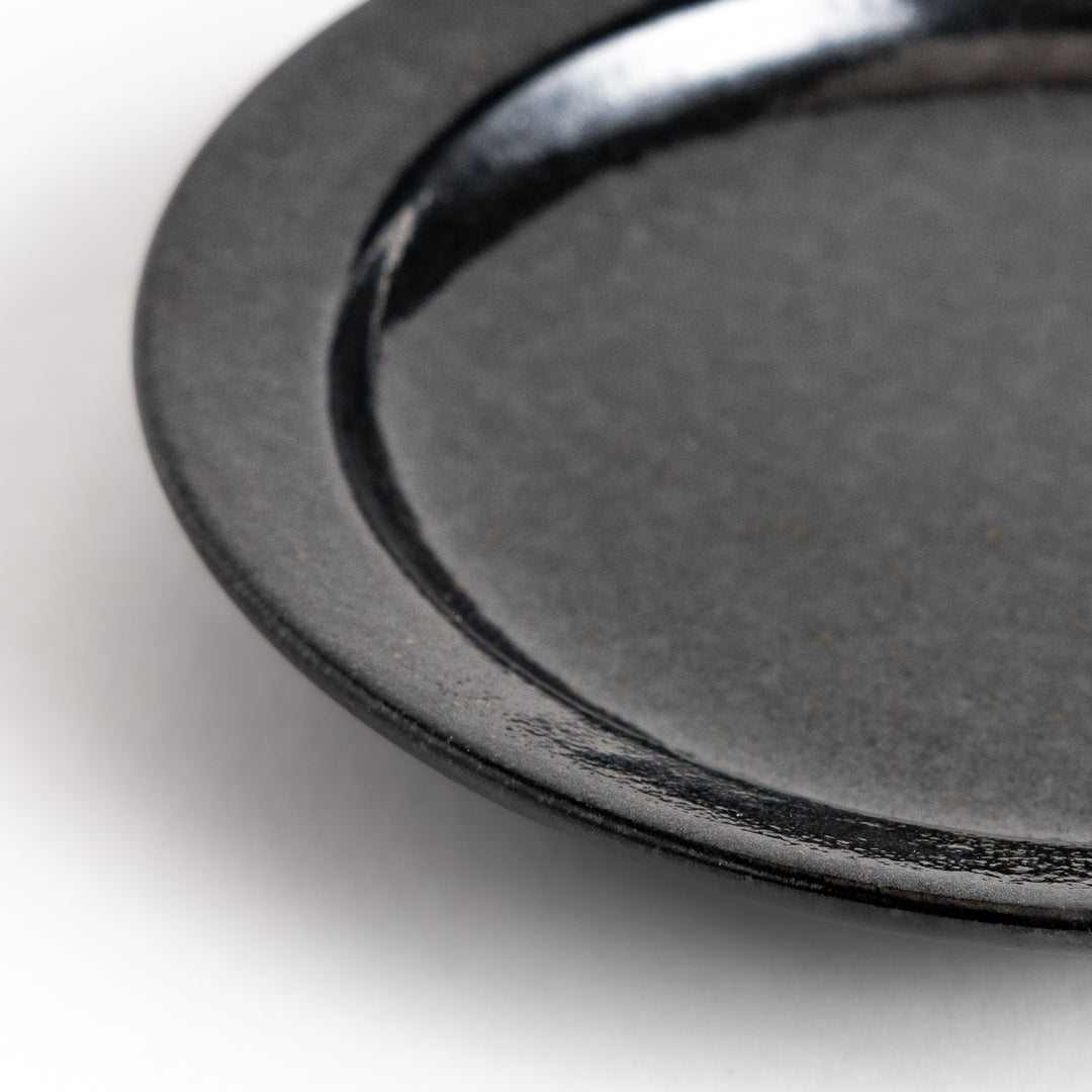 Black ceramic sauce dish with a glossy finish and a minimalist design, ideal for serving dips or condiments elegantly.