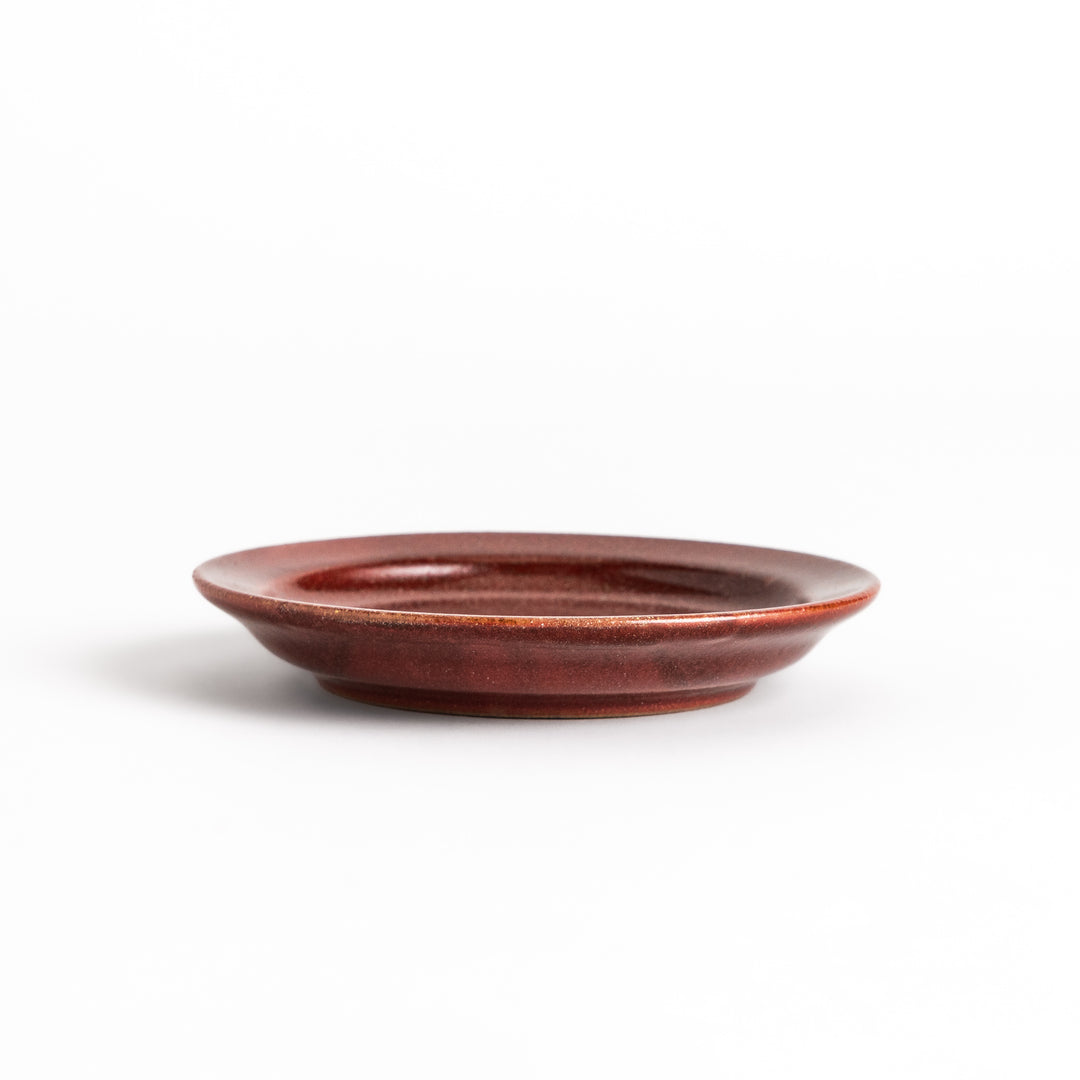 Red ceramic sauce dish with a glossy finish and a minimalist design, ideal for serving dips or condiments elegantly.