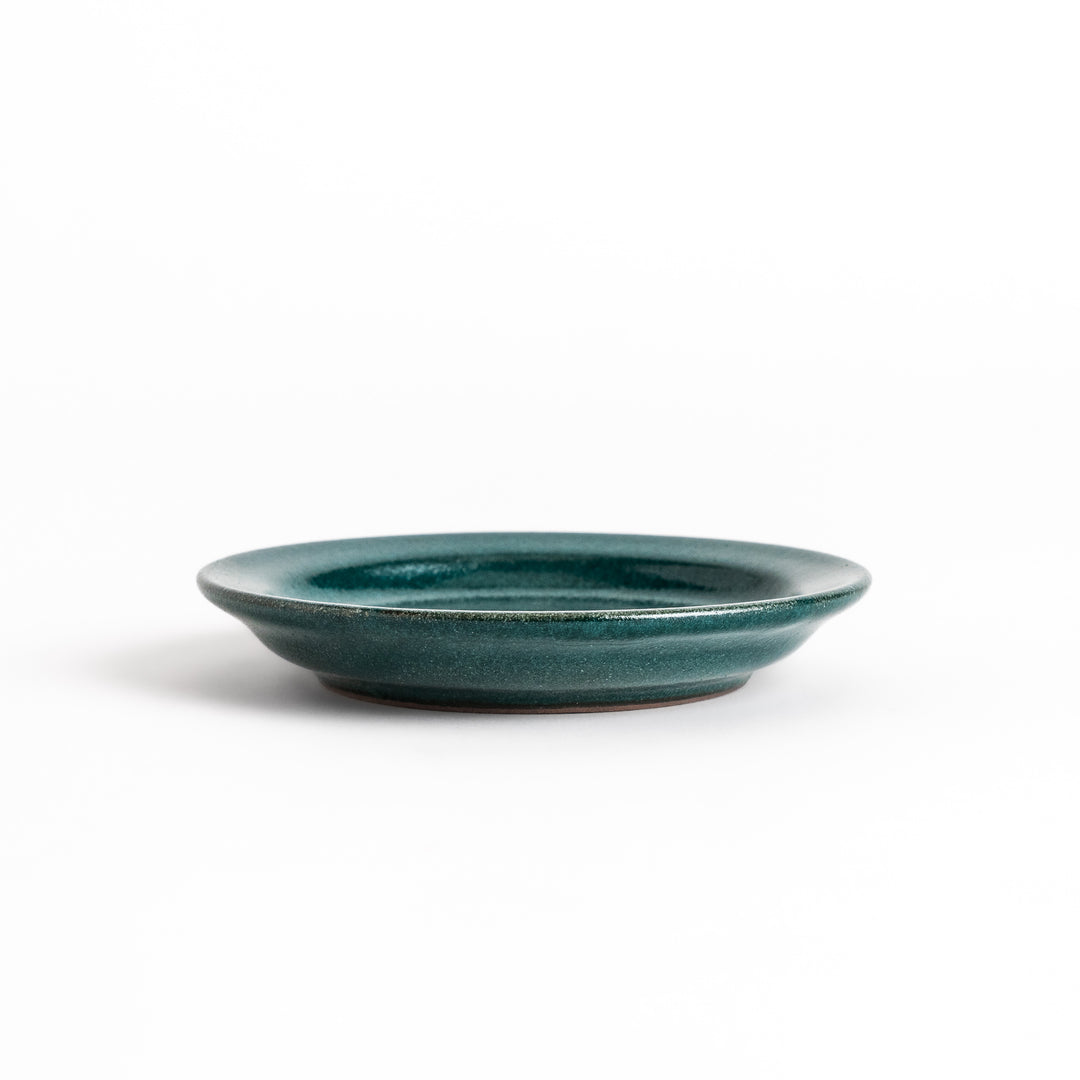 Green ceramic sauce dish with a glossy finish and a minimalist design, ideal for serving dips or condiments elegantly.