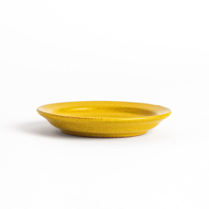 Yellow ceramic sauce dish with a glossy finish and a minimalist design, ideal for serving dips or condiments elegantly.