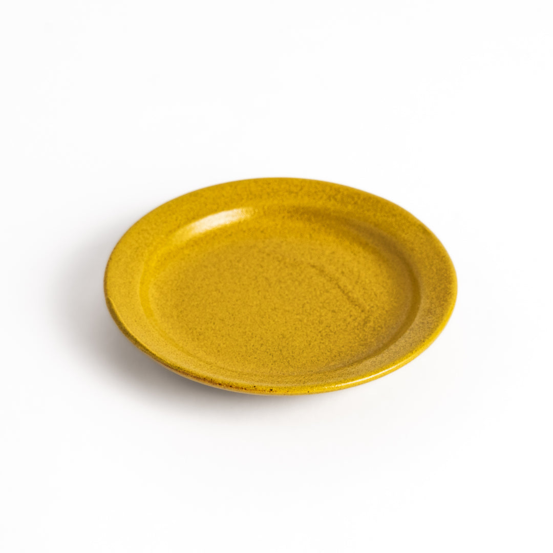 Yellow ceramic sauce dish with a glossy finish and a minimalist design, ideal for serving dips or condiments elegantly.