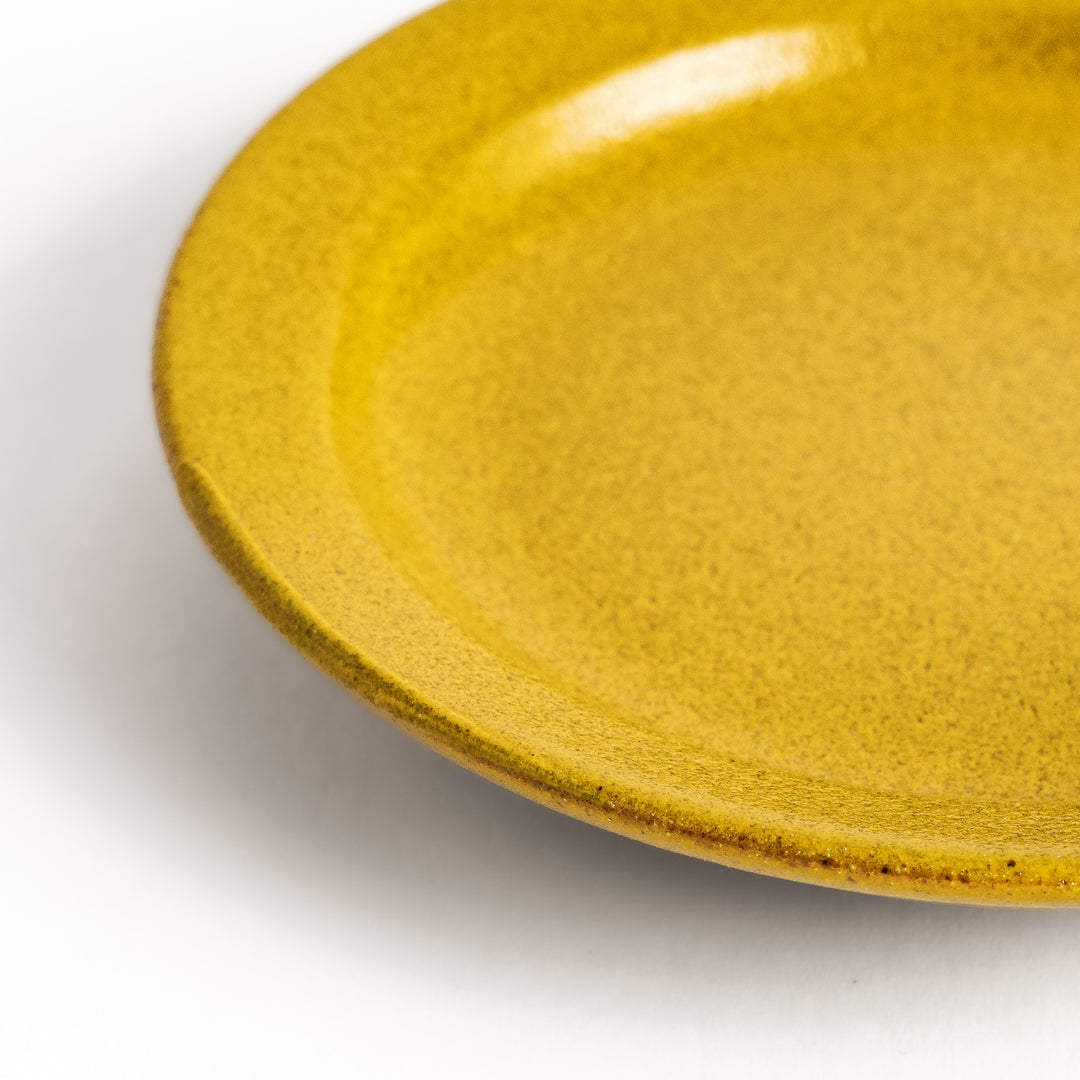 Yellow ceramic sauce dish with a glossy finish and a minimalist design, ideal for serving dips or condiments elegantly.