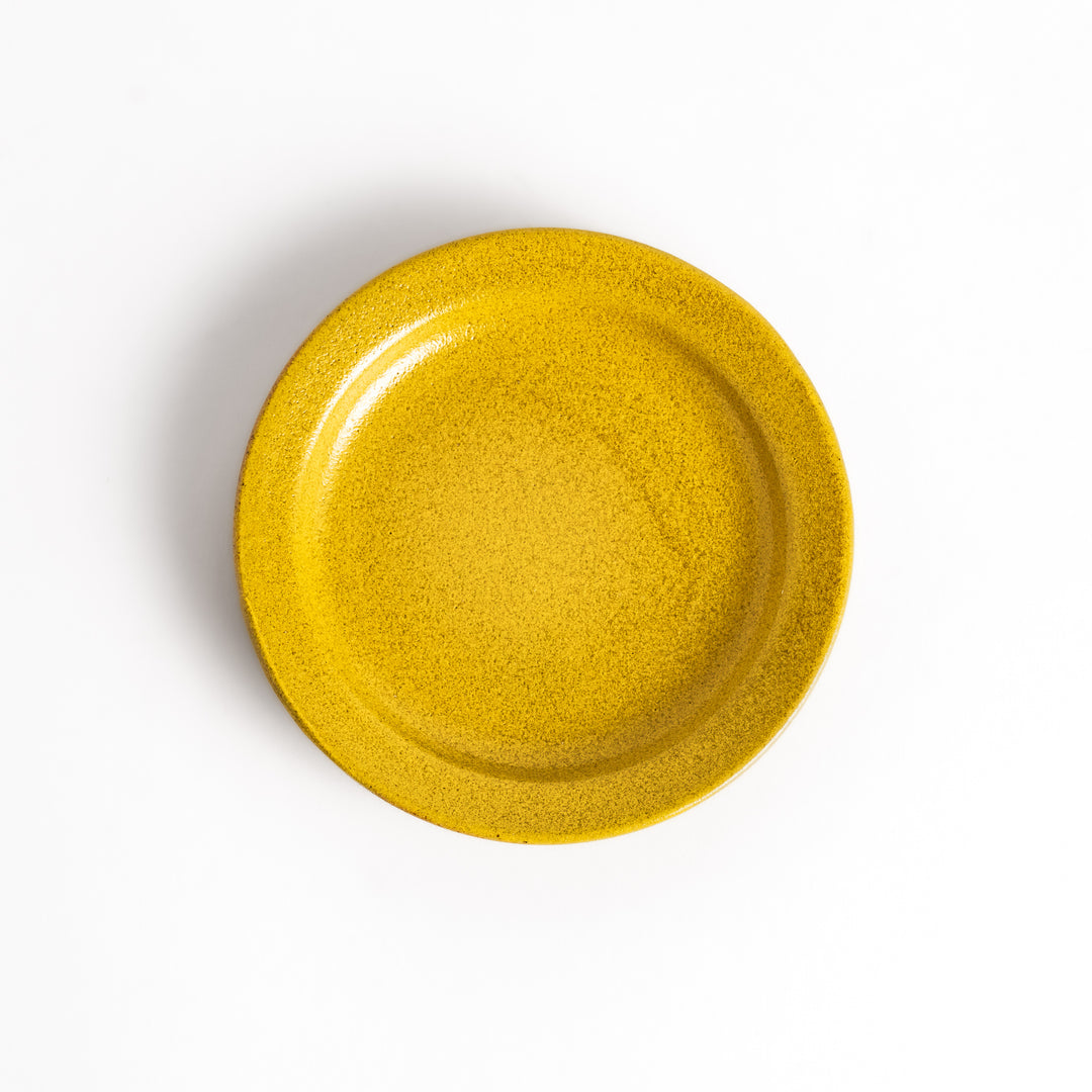 Yellow ceramic sauce dish with a glossy finish and a minimalist design, ideal for serving dips or condiments elegantly.