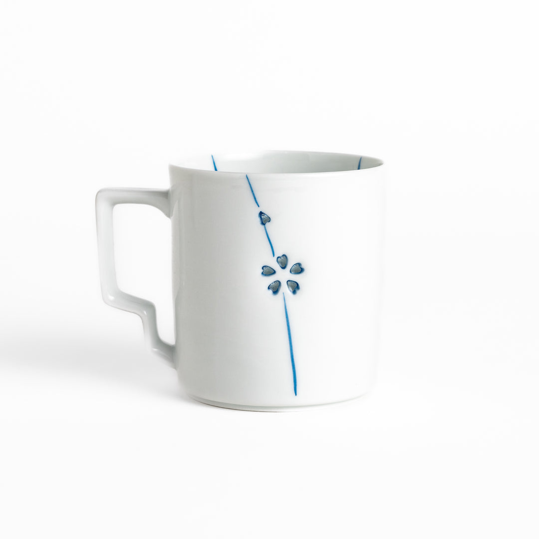 Elegant white ceramic mug with a subtle blue floral pattern, ideal for enjoying your favorite hot beverages.