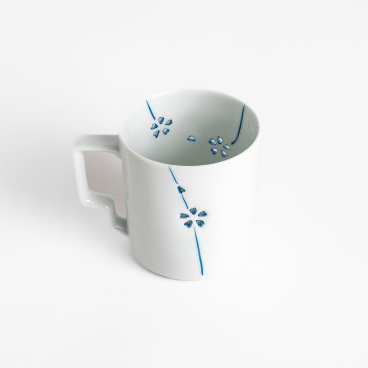 Elegant white ceramic mug with a subtle blue floral pattern, ideal for enjoying your favorite hot beverages.