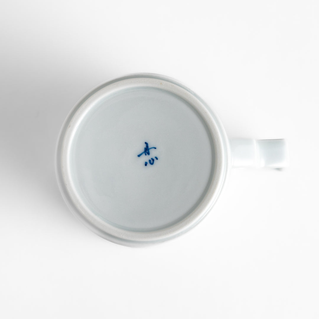 Elegant white ceramic mug with a subtle blue floral pattern, ideal for enjoying your favorite hot beverages.