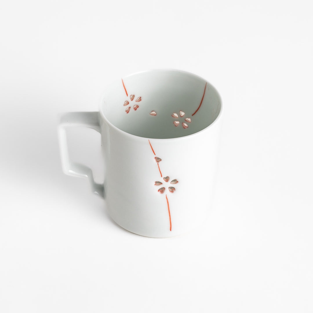 Elegant white ceramic mug with a subtle red floral pattern, ideal for enjoying your favorite hot beverages.