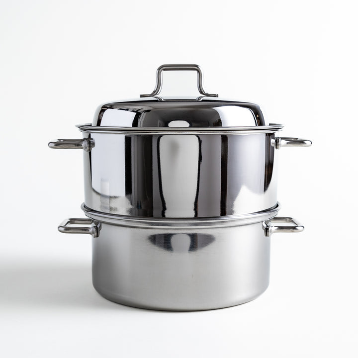 Compact stainless steel steamer with a sleek mirrored lid, featuring a sturdy handle for easy lifting and an elegant finish.