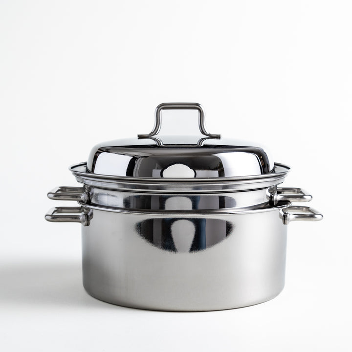 Compact stainless steel steamer lid with a loop handle, designed to fit securely on the steamer base.