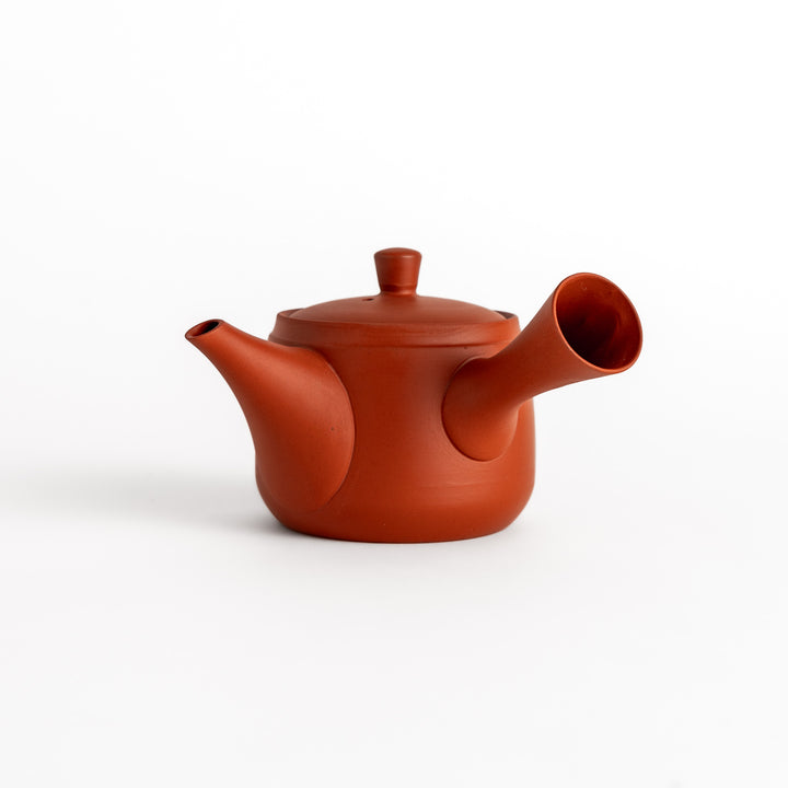 Elegant crimson teapot with a smooth surface and rounded shape, perfect for serving tea with sophistication.