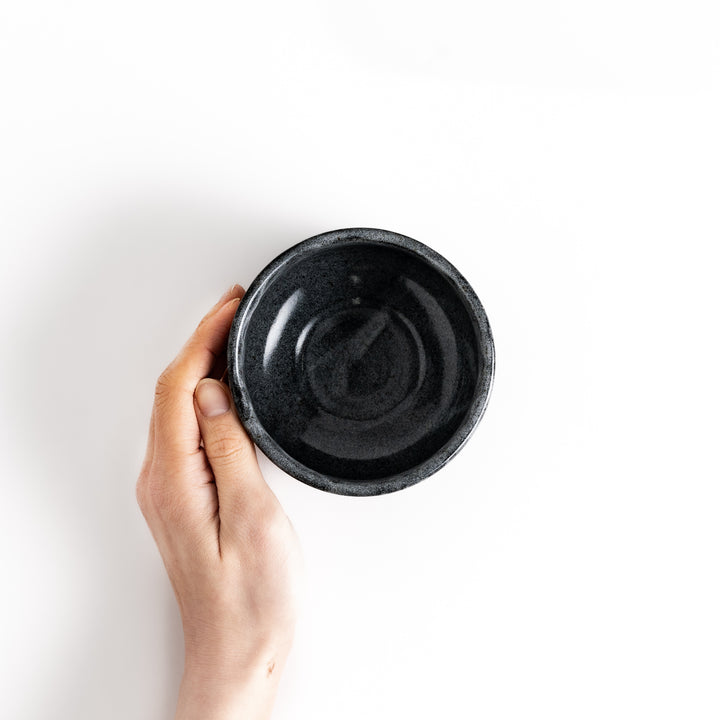 Hand holding a matcha bowl with a smooth glaze, perfect for whisking and enjoying a delicious bowl of matcha.