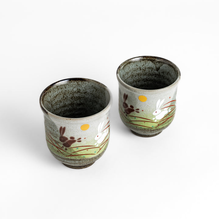 Authentic Japanese tea cups showcasing a delightful rabbit and sun motif, ideal for enjoying traditional Japanese tea.