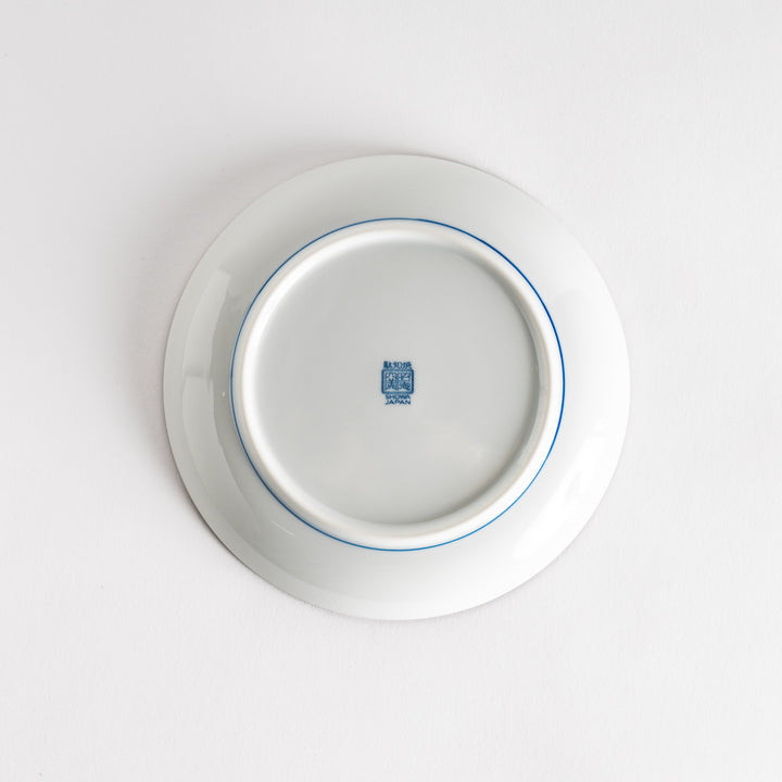 A round dessert plate featuring a bold blue and white lattice pattern.