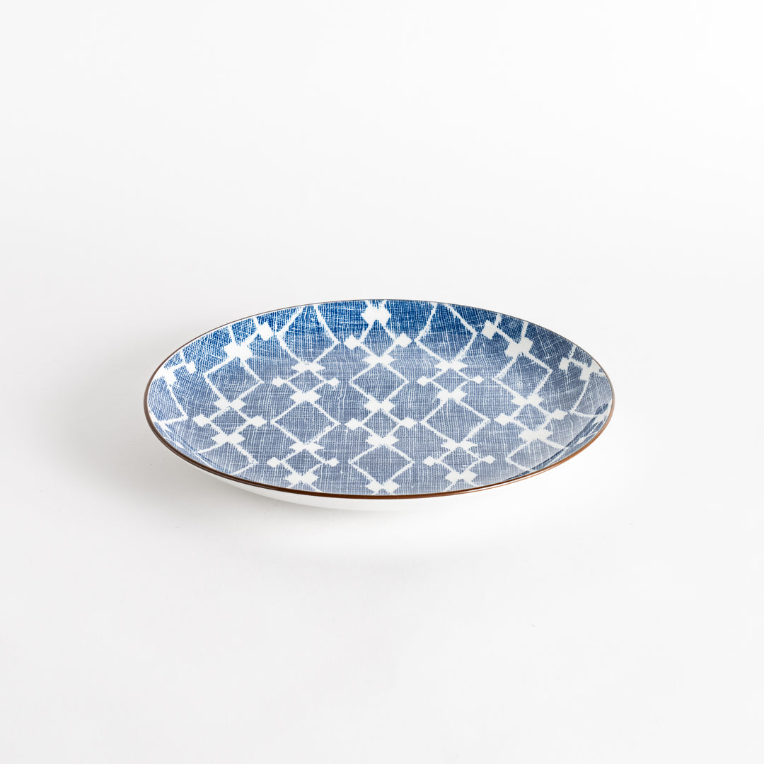 A round dinner plate displaying a blue and white lattice design, similar to traditional Japanese patterns.