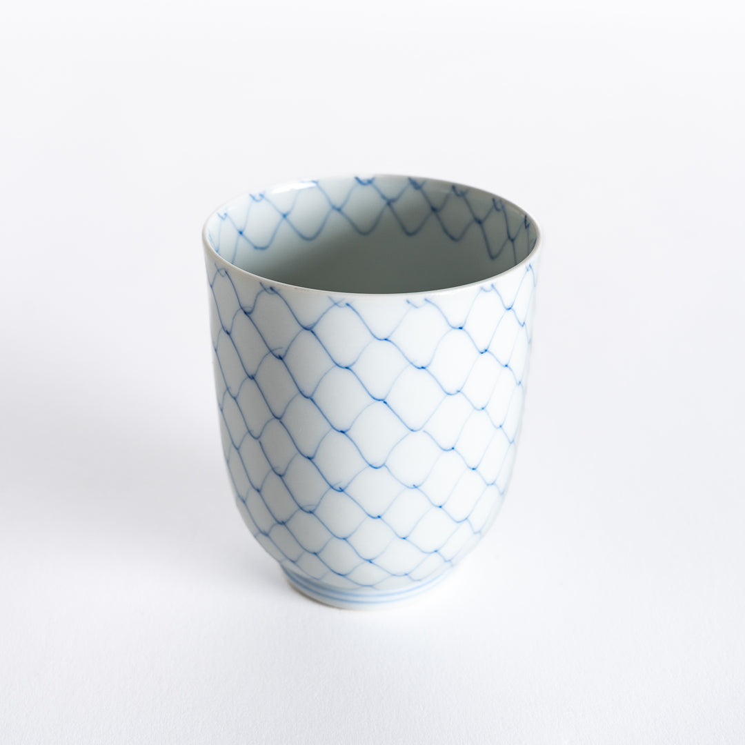 Slightly angled view of the tea cup highlighting the intricate blue diamond weave pattern.