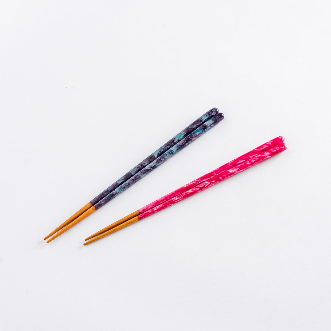 Blue and pink ceramic chopstick rests with a smooth, minimalistic design.