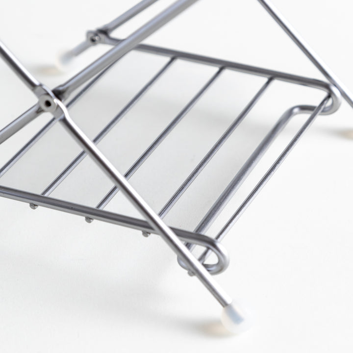 Close-up of the compost holder’s lower frame bars, showcasing the polished stainless steel finish and sturdy build.